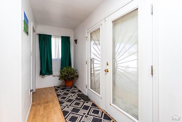 entryway with french doors and wood finished floors