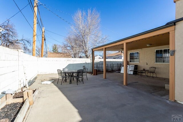 view of patio featuring a fenced backyard and outdoor dining area