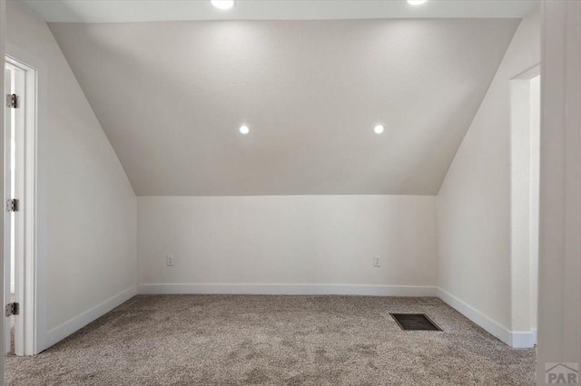 bonus room with lofted ceiling, baseboards, visible vents, and carpet floors