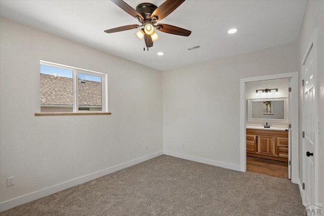 unfurnished bedroom featuring baseboards, visible vents, and carpet
