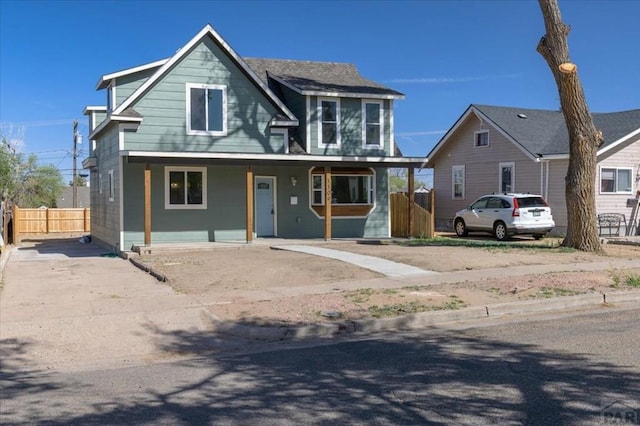 view of front of property with fence and a porch