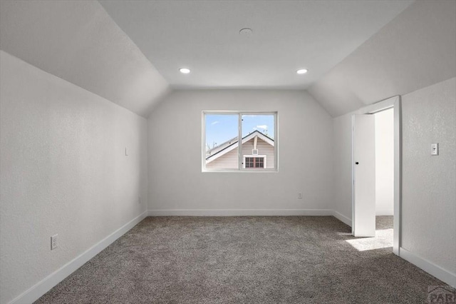 additional living space featuring recessed lighting, vaulted ceiling, carpet flooring, and baseboards