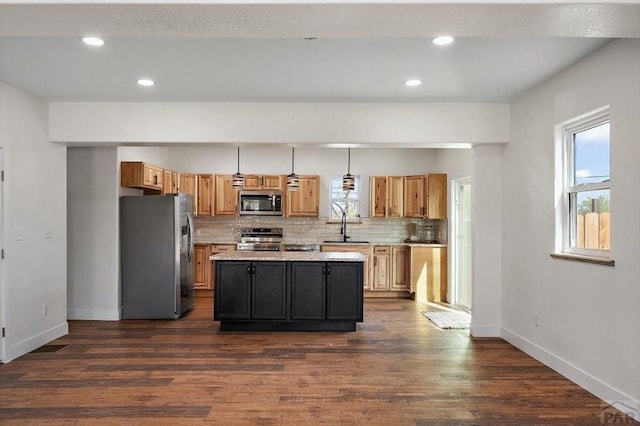 kitchen with stainless steel appliances, light countertops, backsplash, and a healthy amount of sunlight