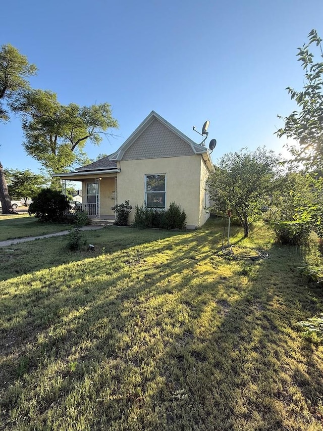 504 Sherman Ave, Ordway, CO 81063 - view of side of home with stucco siding and a yard