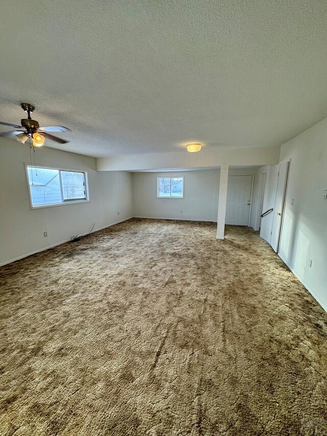 interior space featuring a textured ceiling and ceiling fan