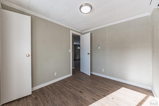 unfurnished bedroom with baseboards, wood finished floors, and ornamental molding