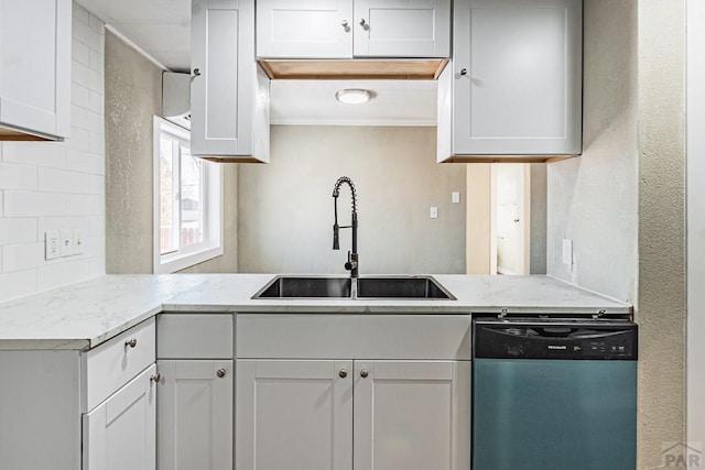 kitchen with tasteful backsplash, light stone countertops, dishwashing machine, a peninsula, and a sink