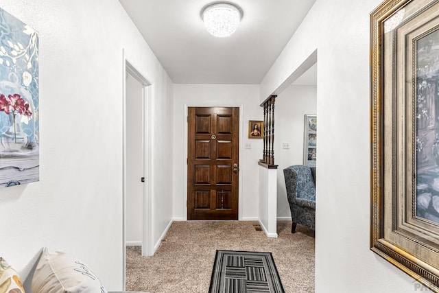 entrance foyer featuring carpet flooring and baseboards