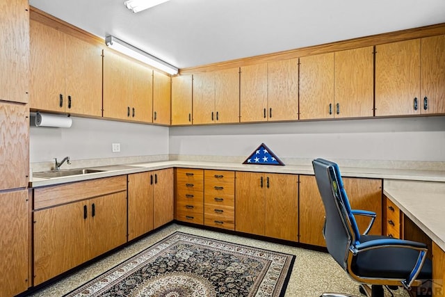 office with built in desk and a sink