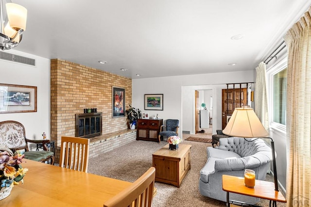 carpeted living area featuring visible vents and a fireplace