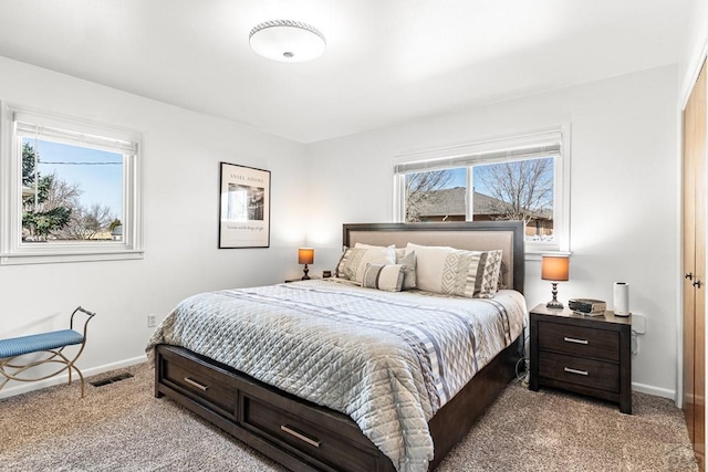 bedroom featuring light carpet, visible vents, and baseboards