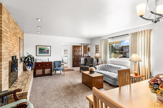 carpeted living room featuring a chandelier and a fireplace