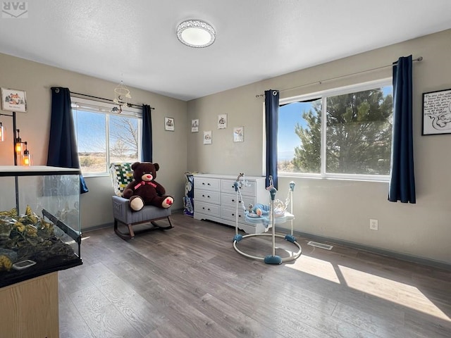 bedroom with baseboards and wood finished floors