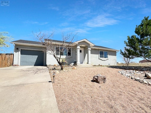 ranch-style home with concrete driveway, stucco siding, fence, and a garage