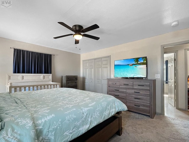 carpeted bedroom featuring a closet and ceiling fan