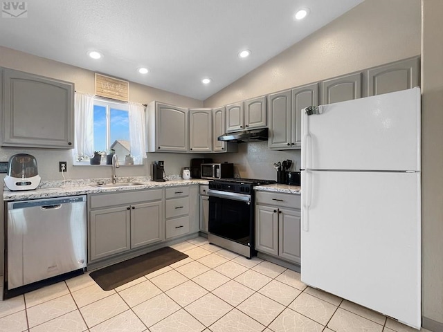 kitchen featuring range with gas stovetop, freestanding refrigerator, gray cabinetry, under cabinet range hood, and dishwasher