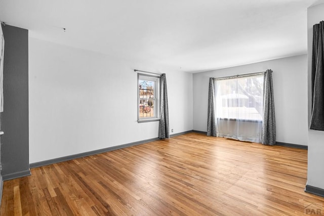 empty room with wood finished floors and baseboards