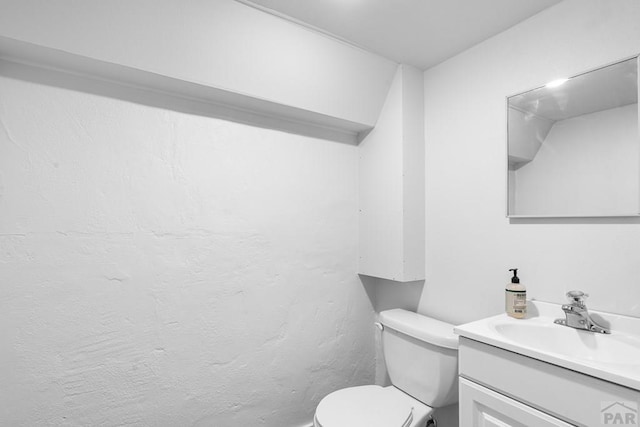 bathroom with toilet and vanity