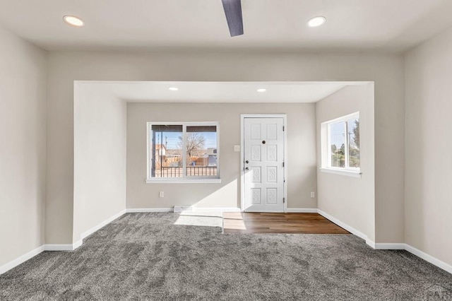 foyer entrance featuring dark colored carpet, baseboards, and recessed lighting