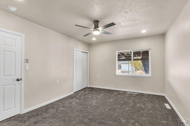 unfurnished bedroom featuring ceiling fan, recessed lighting, dark carpet, and baseboards