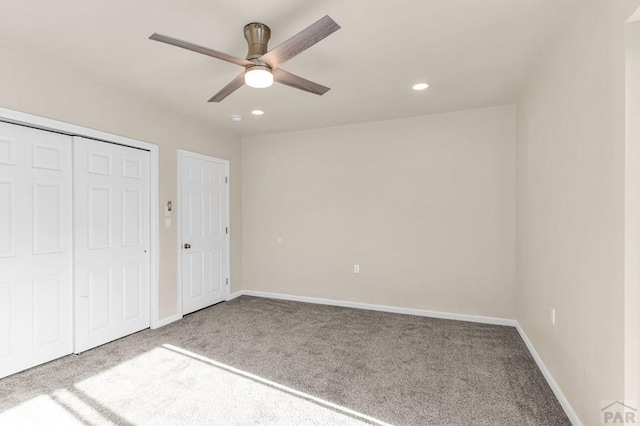 unfurnished bedroom with recessed lighting, a closet, carpet flooring, and baseboards