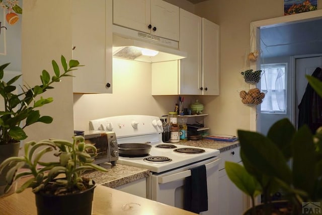 kitchen featuring light countertops, electric range, white cabinets, and under cabinet range hood