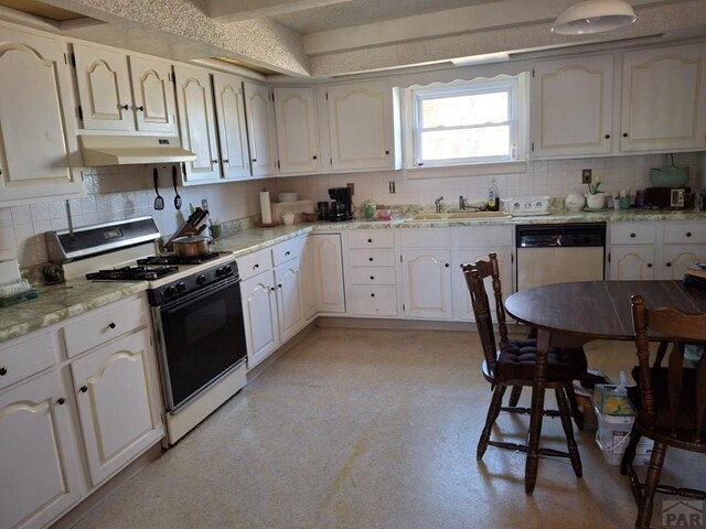 kitchen featuring white cabinets, dishwasher, gas range oven, under cabinet range hood, and a sink