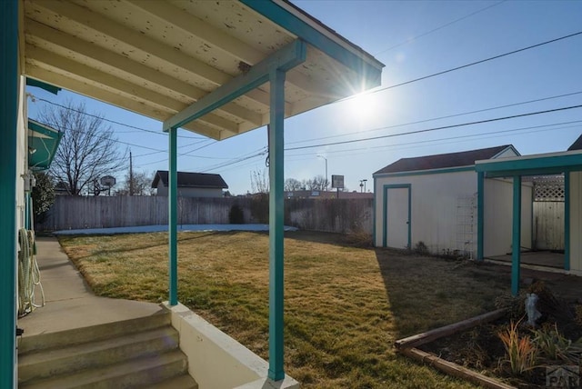 view of yard featuring a fenced backyard, a shed, and an outdoor structure