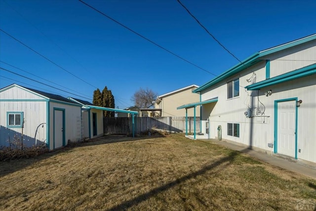 view of yard featuring fence and an outdoor structure