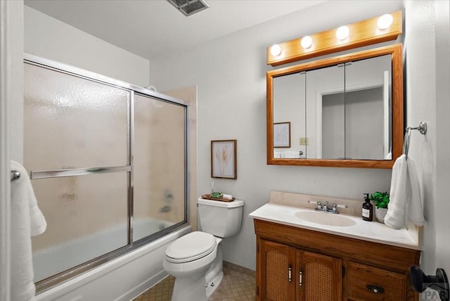 bathroom with visible vents, vanity, toilet, and bath / shower combo with glass door