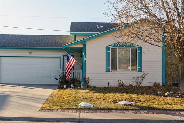 view of front of property featuring an attached garage, concrete driveway, and a front yard