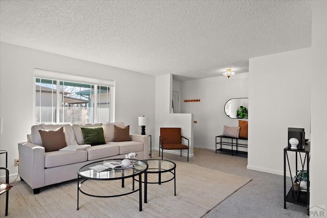 living room featuring light carpet, a textured ceiling, and baseboards