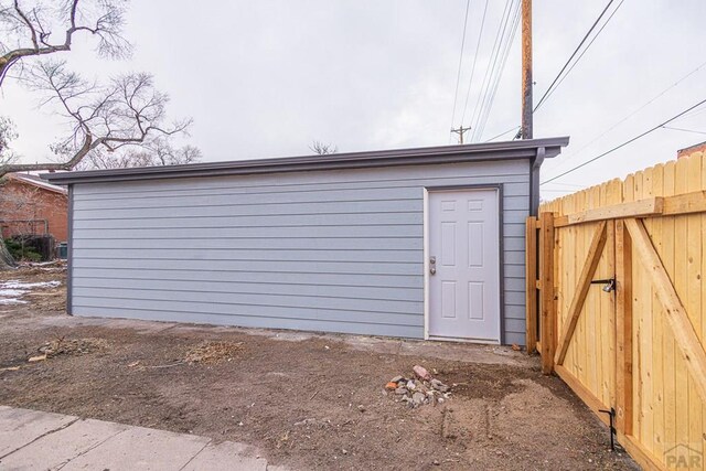 view of outbuilding with an outdoor structure and fence