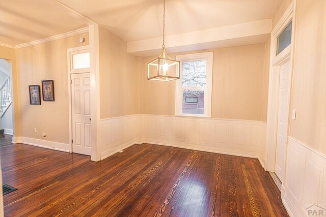 unfurnished dining area with stairs, wainscoting, dark wood-style floors, and visible vents