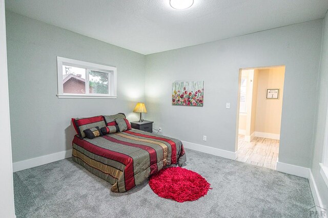 carpeted bedroom with baseboards