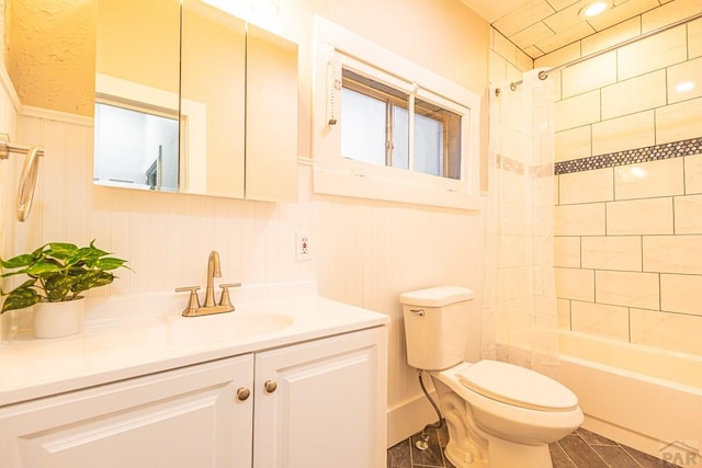 121 W Evans Ave, Pueblo, CO 81004 - full bath with toilet, shower / tub combination, a decorative wall, vanity, and wainscoting