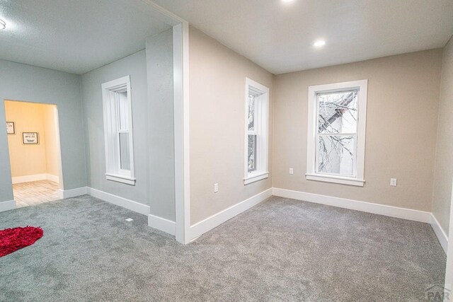 empty room with recessed lighting, carpet flooring, and baseboards