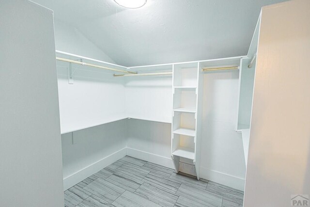 walk in closet featuring lofted ceiling