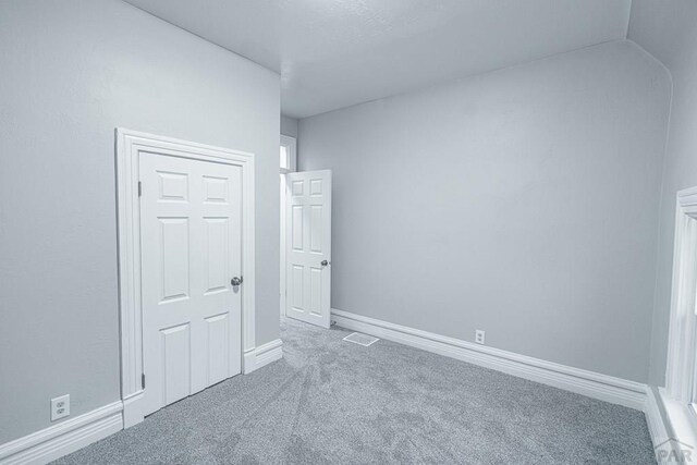121 W Evans Ave, Pueblo, CO 81004 - empty room featuring baseboards, carpet flooring, and visible vents