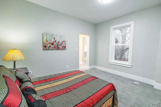 carpeted bedroom featuring baseboards