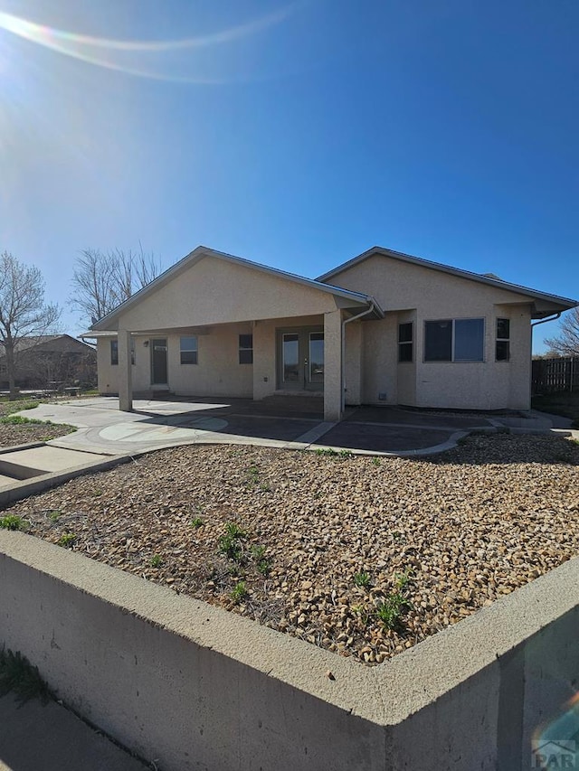 single story home with a patio area and stucco siding