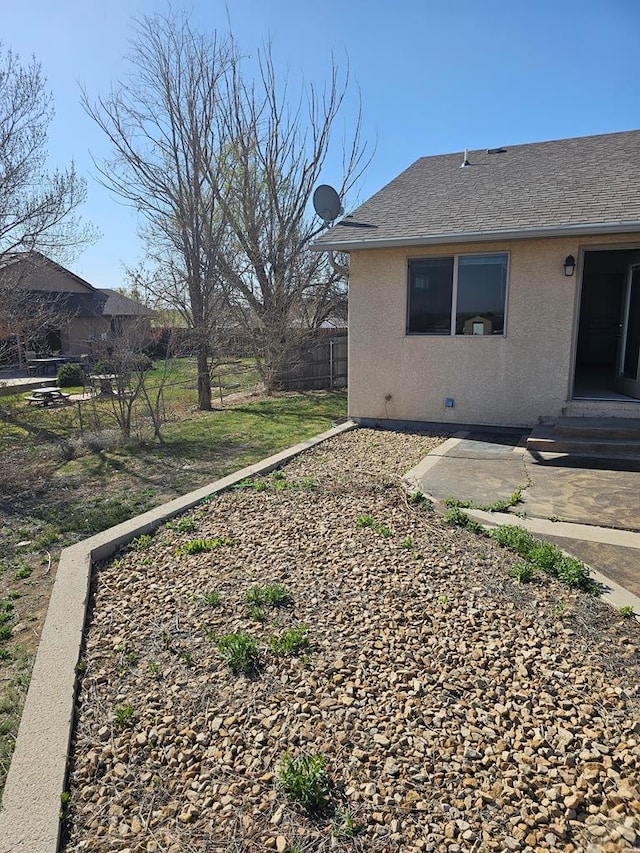view of yard with entry steps, fence, and a patio