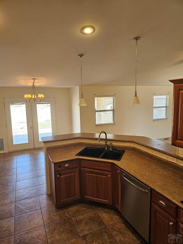 kitchen featuring a sink, pendant lighting, dishwasher, and a healthy amount of sunlight