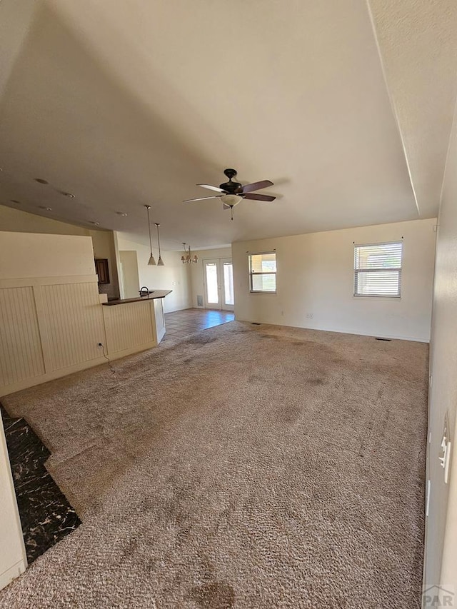 unfurnished living room with a ceiling fan and carpet