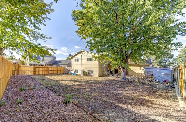 view of yard featuring central air condition unit and a fenced backyard