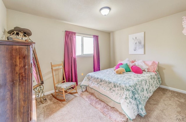 carpeted bedroom featuring baseboards