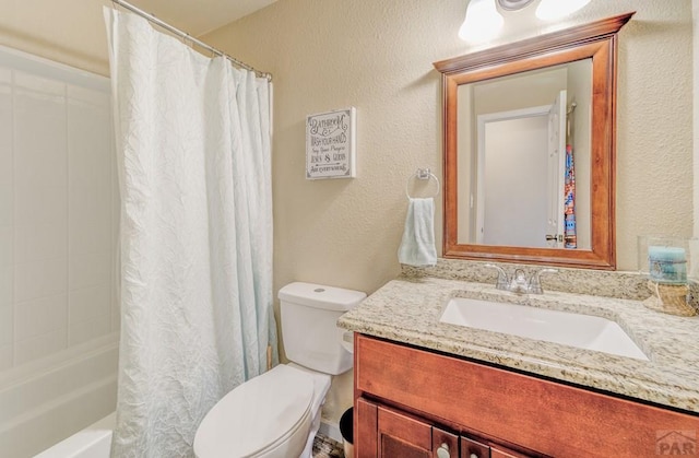 full bath featuring shower / bath combo, toilet, vanity, and a textured wall