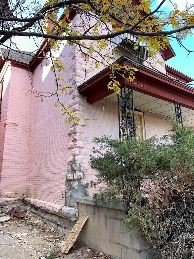 view of side of home featuring brick siding