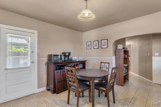 219 E 2nd St, Pueblo, CO 81003 - dining area featuring wainscoting and arched walkways