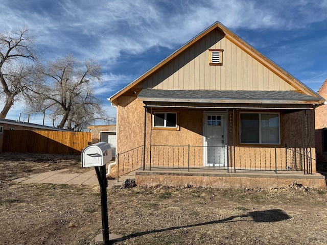 view of front of house featuring covered porch and a shingled roof